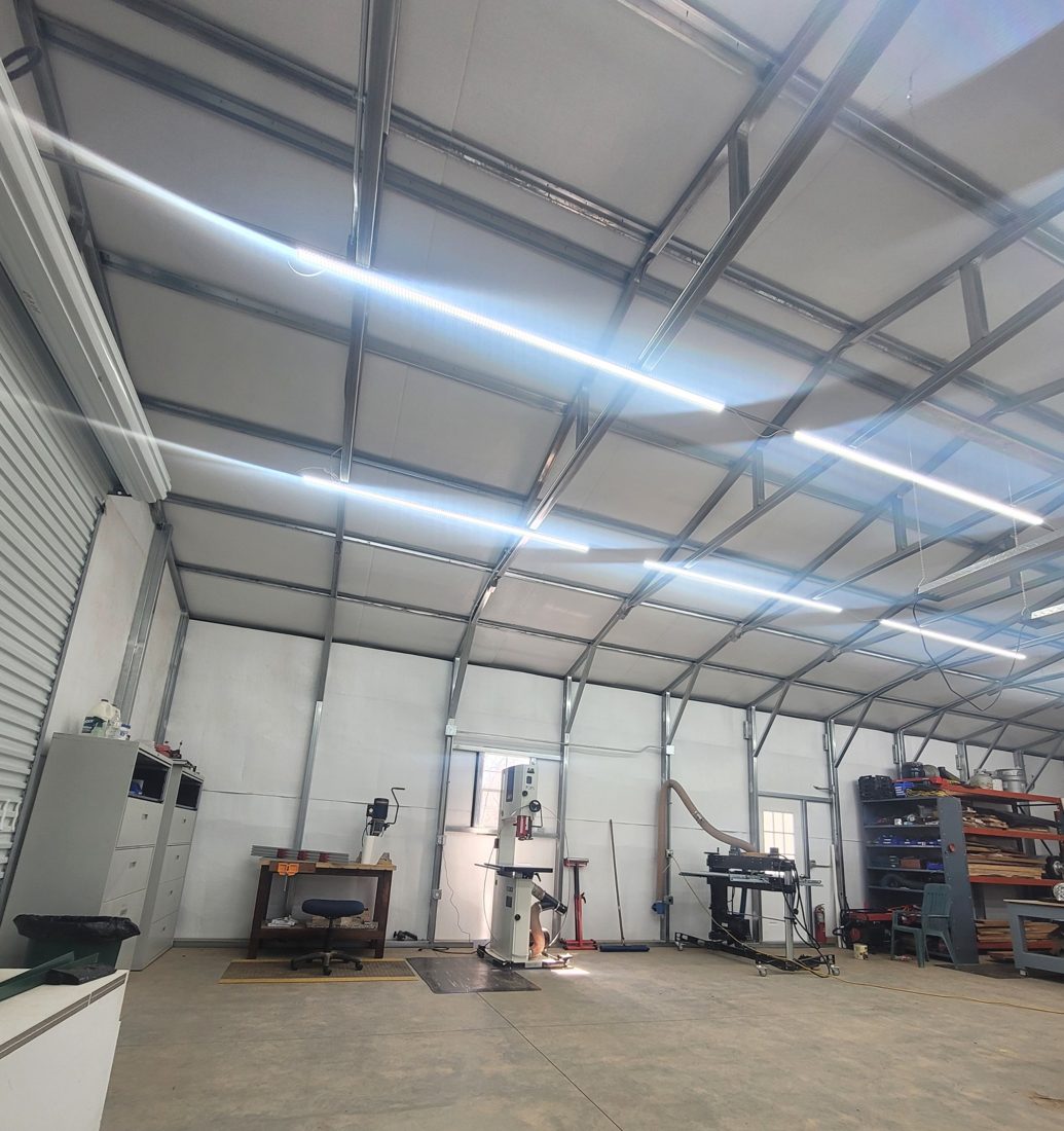 LED strip lighting installed across a workshop ceiling
