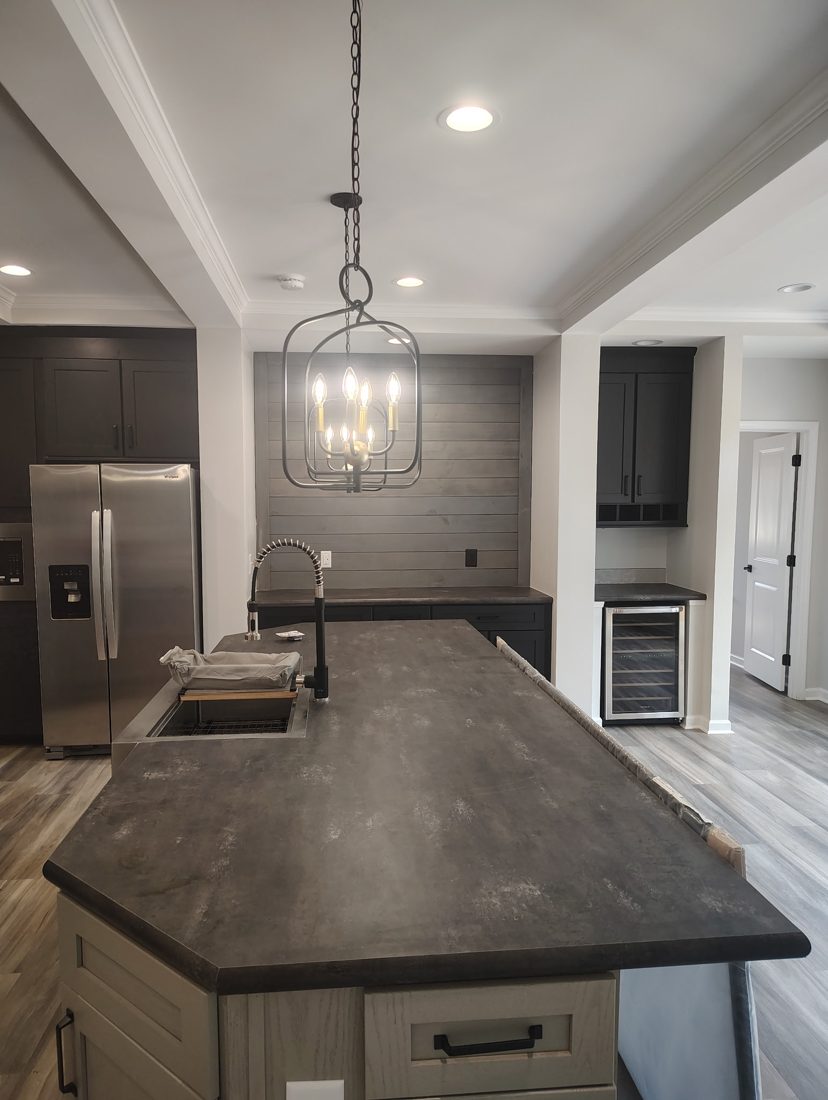 Pendant light and recessed lighting installed over a kitchen island